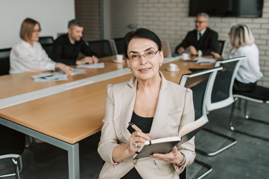 Senior businesswoman leading a meeting with colleagues - representing expert coaching guidance